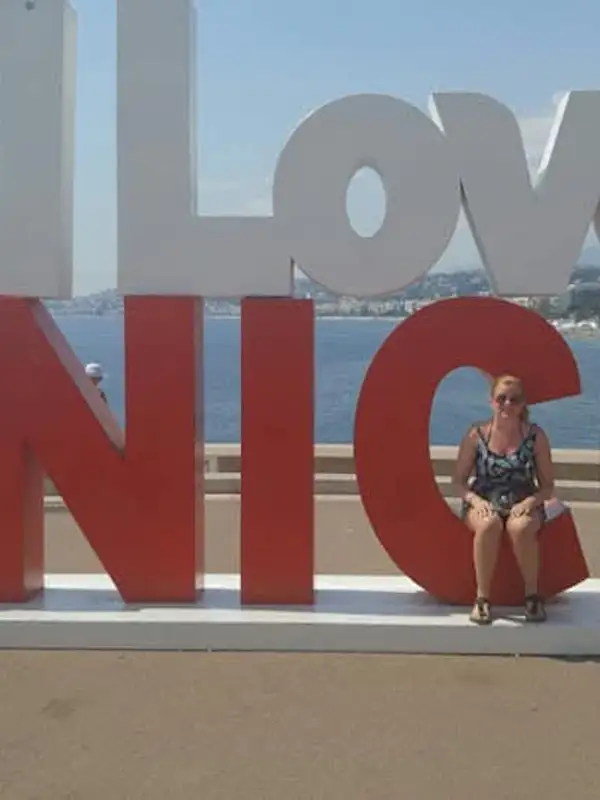 girl posing in front of I Love Nice sign