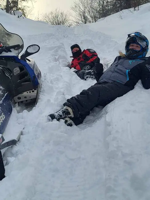 two people rolling around in the snow