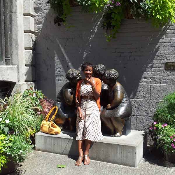 Woman by sculpture in Quebec
