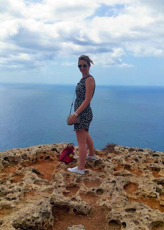 Marleen on rock by coast